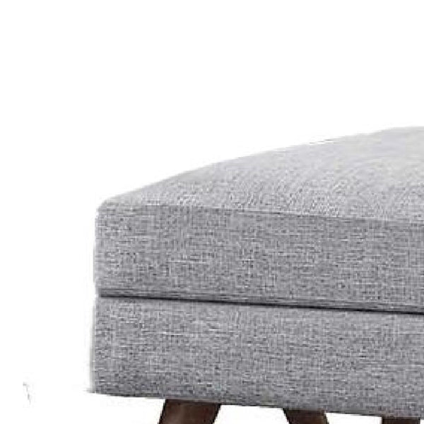 Fabric Upholstered Ottoman With Tappered Wooden Legs, Light Gray and Brown